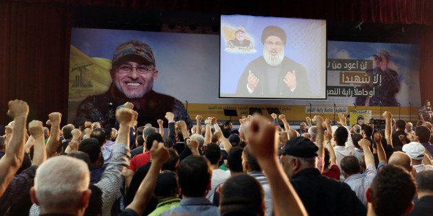 Supporters of Lebanon's Hezbollah leader Sayyed Hassan Nasrallah react as he addresses them from a screen during a ceremony marking the 40th day after Hezbollah commander Mustafa Badreddine(picture on banner) was killed in an attack in Syria, in Beirut's southern suburbs, Lebanon June 24, 2016. REUTERS/Aziz Taher