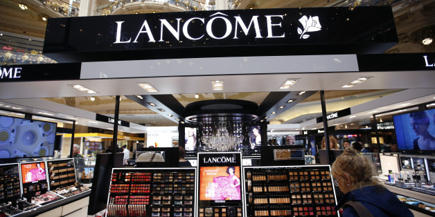 A woman stands in front of a Lancome counter, the cosmetics and perfume brand of French cosmetics group L'Oreal, at a department store in Paris April 20, 2015. L'Oreal posted a 14.1 percent rise in first-quarter sales on Monday, helped by the weak euro and resilient demand for luxury goods products such as Yves Saint Laurent's Black Opium perfume. REUTERS/Charles Platiau