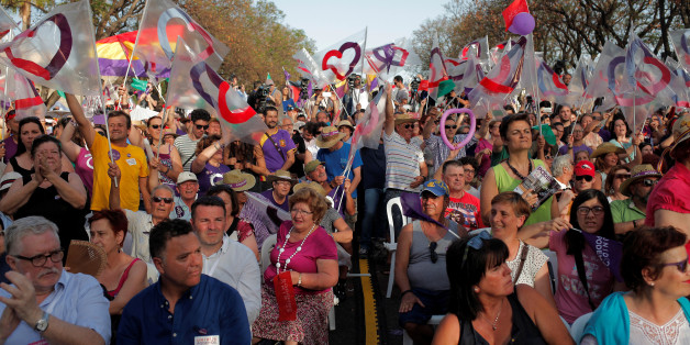 Supporters of Podemos (We Can) leader Pablo Iglesias and Izquierda Unida (United Left) leader Alberto Garzon, now running together in the coalition Unidos Podemos (Together We Can), attend to a campaign rally for Spain's upcoming general election in Jerez de la Frontera, Spain, June 23, 2016. REUTERS/Jon Nazca
