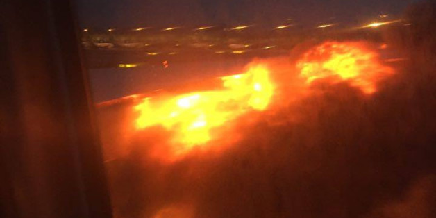 This image provided by Lee Bee Yee shows an engine on fire on a Singapore Airlines flight on Monday, June 27, 2016. A Singapore Airlines statement said the Boeing 777-300ER was on its way to Milan when it turned back "following an engine oil warning message." It says the aircraft's right engine caught fire after Flight SQ368 touched down more than four hours after takeoff. (Lee Bee Yee via AP)