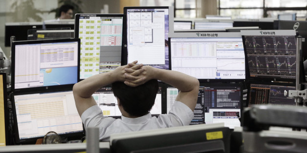 A currency trader watches monitors at the foreign exchange dealing room of the KEB Hana Bank headquarters in Seoul, South Korea, Monday, June 27, 2016. Japanese and Chinese stocks rose Monday but other Asian markets declined, crude prices fell further and U.S. shares appeared headed for a lower opening as jittery traders watched for more fallout from Britain's vote to exit the European Union. (AP Photo/Ahn Young-joon)