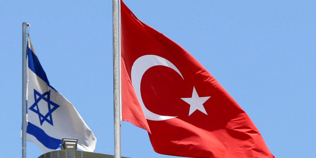 A Turkish flag flutters atop the Turkish embassy as an Israeli flag is seen nearby, in Tel Aviv, Israel June 26, 2016. Picture taken June 26, 2016. REUTERS/Baz Ratner