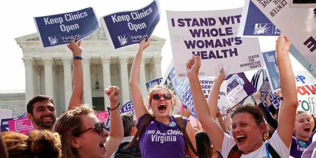 Demonstrators celebrate at the U.S. Supreme Court after the court struck down a Texas law imposing strict regulations on abortion doctors and facilities that its critics contended were specifically designed to shut down clinics in Washington June 27, 2016. REUTERS/Kevin Lamarque TPX IMAGES OF THE DAY