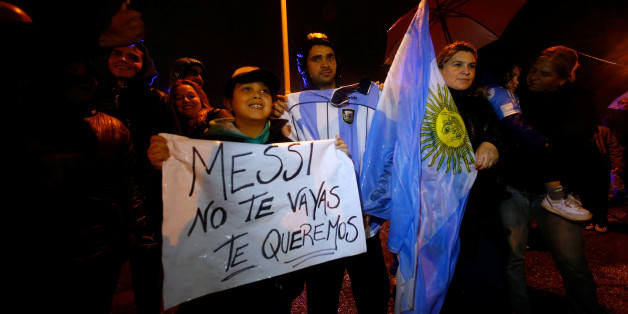 A boy holds a sign that reads "Messi, don't go, we love you" as he waits for Argentina's soccer team to arrive to their training camp after their participation in the 2016 Copa America Centenario, in Buenos Aires, Argentina, June 27, 2016. REUTERS/Marcos Brindicci