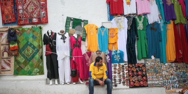 A shop owner waits for tourists outside his shop at the touristic village of Sidi Bou Said, some 20 kilometers outside of Tunis, Tunisia, Sunday, Oct. 25, 2015. (AP Photo/Mosa'ab Elshamy)