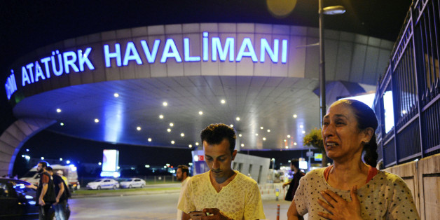 People gather on the entrance to Istanbul's Ataturk airport, early Wednesday, June 29, 2016. Suspected Islamic State group extremists have hit the international terminal of Istanbul's Ataturk airport, killing dozens of people and wounding many others, Turkish officials said Tuesday. Turkish authorities have banned distribution of images relating to the Ataturk airport attack within Turkey. (AP Photo/Emrah Gurel) TURKEY OUT