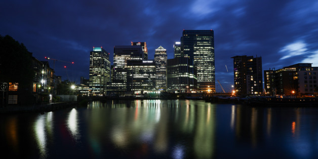 The No. 1 Canada Square skyscraper, center, stands surrounded by office buildings illuminated at night in the Canary Wharf financial, shopping and business district on the banks of the River Thames in London, U.K., on Tuesday, June 21, 2016. Financial and related services accounted for 11.8 percent of U.K. economic output, or 190 billion pounds ($278 billion), in 2014, and quitting the EU could cost as many as 100,000 jobs in the sector by 2020, according to industry group TheCityUK. Photographe