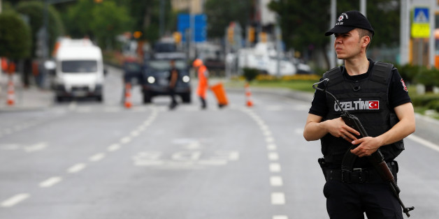 A police officer stands guard near the site where a Turkish police bus was targeted in a bomb attack in a central Istanbul district, Turkey, June 7, 2016. REUTERS/Osman Orsal