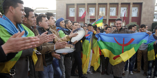 Members of the Moroccan Amazigh Berber community sing and wave the Amazigh flag as they celebrate on the eve of the 2964th Amazigh new year near the parliament in Rabat January 12, 2014. REUTERS/Stringer (MOROCCO - Tags: ANNIVERSARY POLITICS)