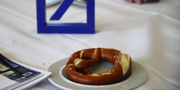 The emblem of Deutsche Bank is pictured on a table next to a pretzel in the catering area during the bank's annual general meeting in Frankfurt, Germany, May 19, 2016. REUTERS/Kai Pfaffenbach