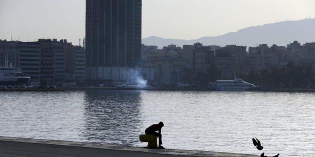 A migrant sits at the Athens port of Piraeus, Monday April 4, 2016, during the first day of the implementation of the deal between EU and Turkey. Under the deal, migrants arriving illegally in Greece will be returned to Turkey if they do not apply for asylum or if they make an asylum claim that is rejected. (AP Photo/Lefteris Pitarakis)