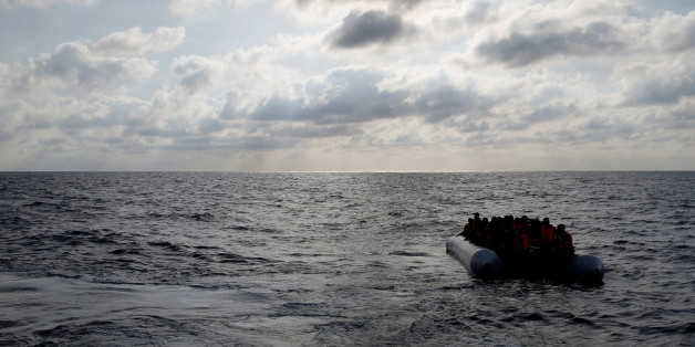 Migrants in a dinghy await rescue by the Migrant Offshore Aid Station (MOAS) around 20 nautical miles off the coast of Libya, June 23, 2016. Picture taken June 23, 2016. REUTERS/Darrin Zammit Lupi MALTA OUT. NO COMMERCIAL OR EDITORIAL SALES IN MALTA TPX IMAGES OF THE DAY