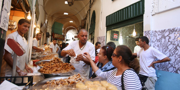 Women buys traditional sweets during the holy fasting month of Ramadan in Tunis, Tunisia, June 22, 2016. REUTERS/Zoubeir Souissi