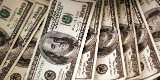 Four thousand U.S. dollars are counted out by a banker counting currency at a bank in Westminster, Colorado November 3, 2009. REUTERS/Rick Wilking/File Photo