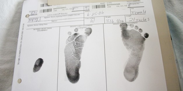 Newborn baby footprints on official document
