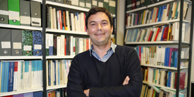 French economist and academic Thomas Piketty, poses in his book-lined office at the French School for Advanced Studies in the Social Sciences (EHESS), in Paris May 12, 2014. The 43-year-old Piketty's book "Capital in the Twenty-First Century" has attracted praise and invective alike on its way to the top of the Amazon.com books best-seller list. Picture taken May 12, 2014. REUTERS/Charles Platiau (FRANCE - Tags: POLITICS SOCIETY BUSINESS EDUCATION)