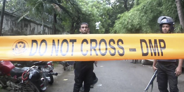 Bangladeshi security forces block the road after militants took hostages at a restaurant popular with foreigners in Dhaka, Bangladesh, Saturday, July 2, 2016. Bangladeshi forces stormed the Holey Artisan Bakery in Dhaka's Gulshan area where heavily armed militants held dozens of people hostage Saturday morning, rescuing some captives including foreigners at the end of the 10-hour standoff. (AP Photo)