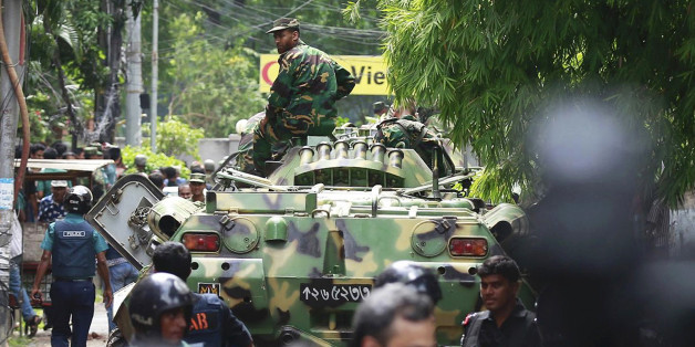 Bangladeshi soldiers and security personnel sit on top of armored vehicles as they cordon off an area near a restaurant popular with foreigners after heavily armed militants took dozens of hostages, in a diplomatic zone of the Bangladeshi capital Dhaka, Bangladesh, Saturday, July 2, 2016. Bangladesh forces stormed the Holey Artisan Bakery in Dhaka's Gulshan area Saturday morning, triggering explosions and finding bodies lying in pools of blood. (AP Photo)