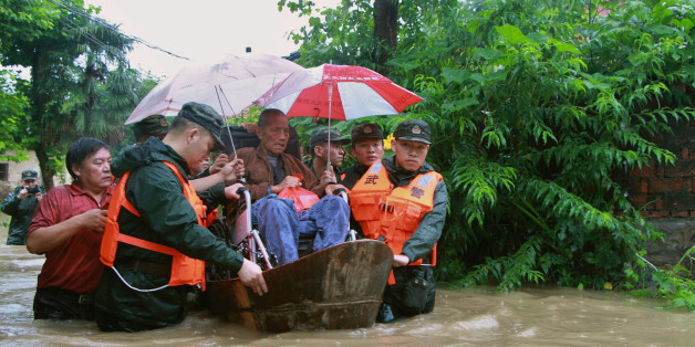 Rescuers save a resident from a flooded area in Anqing, Anhui Province, China, July 2, 2016. REUTERS/Stringer ATTENTION EDITORS - THIS IMAGE WAS PROVIDED BY A THIRD PARTY. EDITORIAL USE ONLY. CHINA OUT. NO COMMERCIAL OR EDITORIAL SALES IN CHINA. THIS PICTURE WAS PROCESSED BY REUTERS TO ENHANCE QUALITY. AN UNPROCESSED VERSION HAS BEEN PROVIDED SEPARATELY.