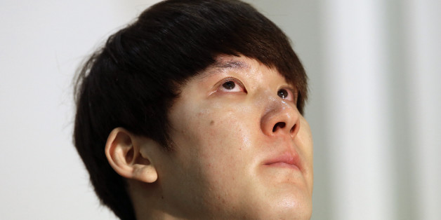 In this Friday, March 27, 2015, file photo, Former Olympic swimming champion Park Tae-hwan of South Korea holds back tears during a news conference in Seoul, South Korea. Former Olympic swimming champion Park Tae-hwan of South Korea offered a public apology Friday, four days after receiving an 18-month ban for failing a doping test. (AP Photo/Lee Jin-man)