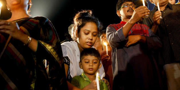 DHAKA, BANGLADESH - 2016/07/03: A boy with his family attends a candle-light ceremony to pay tribute to the people who have been killed in a terrorists attack at the Holey Artisan Bakery, in Dhaka,