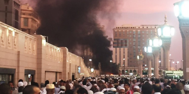 In this photo provided by Noor Punasiya, people stand by an explosion site in Medina, Saudi Arabia, Monday, July 4, 2016. State-linked Saudi news websites reported an explosion Monday near one of Islam's holiest sites in the city of Medina, as two suicide bombers struck in different cities. (Courtesy of Noor Punasiya via AP)