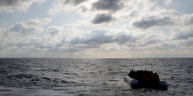 Migrants in a dinghy await rescue by the Migrant Offshore Aid Station (MOAS) around 20 nautical miles off the coast of Libya, June 23, 2016. Picture taken June 23, 2016. REUTERS/Darrin Zammit Lupi MALTA OUT. NO COMMERCIAL OR EDITORIAL SALES IN MALTA TPX IMAGES OF THE DAY