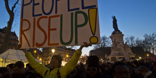 People gather on the Place de la Republique in Paris, France, Friday, April 8, 2016. Thousands of protesters have been camping out, holding night-time demonstrations since last week at a symbolic rallying point on the Place de la Republique, to express anger at a proposed labor law and social conditions in France. The social media-driven movement, called "Nuit Debout" or "Rise up at Night," sprang from nationwide strikes and protests last week. (AP Photo/Michel Euler)