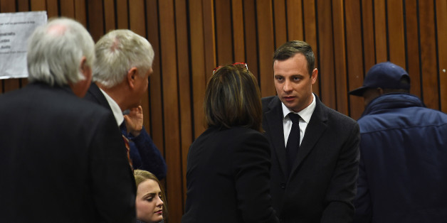 Olympic and Paralympic track star Oscar Pistorius speaks with his legal team ahead of his sentence hearing at the North Gauteng High Court in Pretoria, South Africa, July 6, 2016. REUTERS/Masi Losi/Pool