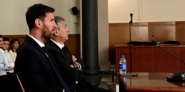 Barcelona's Argentine soccer player Lionel Messi (L) sits in court with his father Jorge Horacio Messi during their trial for tax fraud in Barcelona, Spain, June 2, 2016. REUTERS/Alberto Estevez/Pool/Files