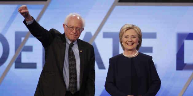 Democratic U.S. presidential candidates Senator Bernie Sanders and Hillary Clinton pose before the start of the Univision News and Washington Post Democratic U.S. presidential candidates debate in Kendall, Florida March 9, 2016. REUTERS/Carlo Allegri