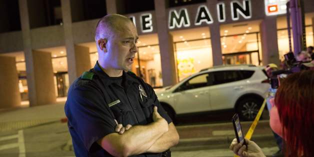 A police officer tries to calm protestors following the sniper shooting in Dallas on July 7, 2016. A fourth police officer was killed and two suspected snipers were in custody after a protest late Thursday against police brutality in Dallas, authorities said. One suspect had turned himself in and another who was in a shootout with SWAT officers was also in custody, the Dallas Police Department tweeted. / AFP / Laura Buckman (Photo credit should read LAURA BUCKMAN/AFP/Getty Images)