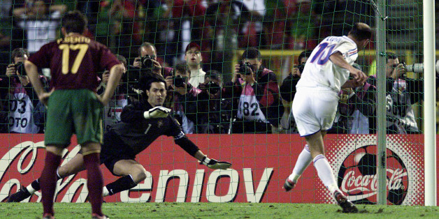 France's Zinedine Zidane (R) scores his extra time golden penalty goal against Portugal's goal keeper Vitor Baia (C) as his team mate Paulo Bento (L) looks on in their European championship semi-finals June 28. France wins 2-1 and will go on to play in the finals.JL/JES