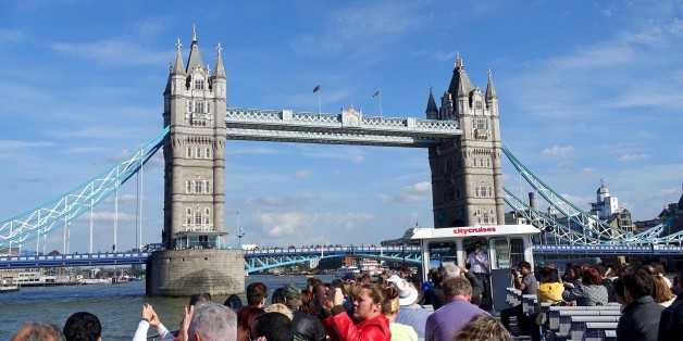 In this May 21, 2015 photo, a London City Cruises boat tours the River Thames near the Tower Bridge in London. Thereâs plenty of sights to see for families on vacation in London, like the Harry Potter studio tour, Big Ben and the London Eye. (AP Photo/Ross D. Franklin)