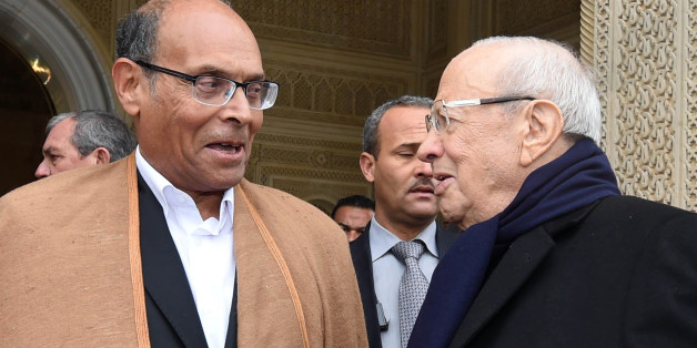 Tunisia's new President, Beji Caid Essebsi, right, shakes hands with out-going President, Moncef Marzouki, during a handover ceremony at the presidential palace in Carthahe outside Tunis, Tunisia, Wednesday, Dec. 31, 2014. Tunisia's new president pledged a rule of reconciliation and consensus as he took his oath Wednesday before the newly elected parliament to complete the country's democratic transition. The inauguration of Beji Caid Essebsi, an 88-year-old political veteran, comes in a year in
