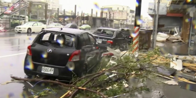 In this image made from video, wind-blown debris from Typhoon Nepartak litters the street and damages a vehicle in Taitung, south eastern Taiwan, Friday, July 8, 2016. Power was partially restored in Taiwan on Friday after Nepartak slammed into the island's eastern coast with ferocious winds and torrential rains. (EBC via AP Video)