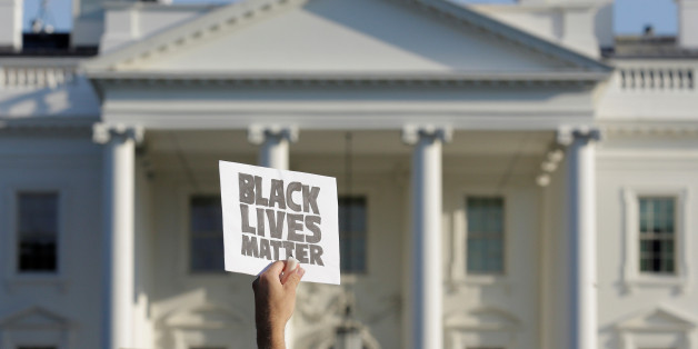 A demonstrator with Black Lives Matter holds up a sign during a protest in front of the White House in Washington, U.S., July 8, 2016. REUTERS/Joshua Roberts