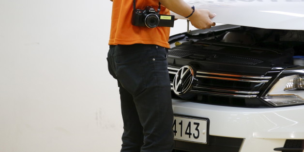 A dealer checks a Volkswagen car at a used car dealership in Seoul, South Korea, October 2, 2015. German carmaker Volkswagen , rocked by a diesel emissions scandal that erupted on Sept 18, saw its sales in South Korea slide 7.8 percent in September from a month earlier, according to industry data released on Tuesday. Picture taken October 2, 2015. REUTERS/Kim Hong-Ji