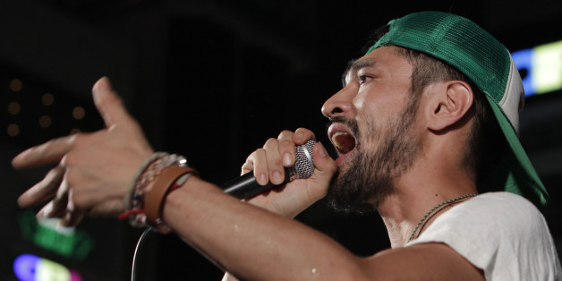 In this photo taken Thursday, July 18, 2013, musician Yohei Miyake, a candidate of the opposition Green Japan Party, delivers his speech at a campaign rally for the July 21 parliamentary elections in Omiya, near Tokyo. Miyake said he wants to spark political interest among inactive voters by breaking out of the stereotypical, uptight image of Japanese political candidates. The event started with live musical performances from guest artists, a message from one of his supporters and ended with Miy