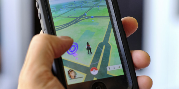 Pokemon Go is displayed on a cell phone in Los Angeles on Friday, July 8, 2016. Just days after being made available in the U.S., the mobile game Pokemon Go has jumped to become the top-grossing app in the App Store. And players have reported wiping out in a variety of ways as they wander the real world, eyes glued to their smartphone screens, in search of digital monsters. (AP Photo/Richard Vogel)
