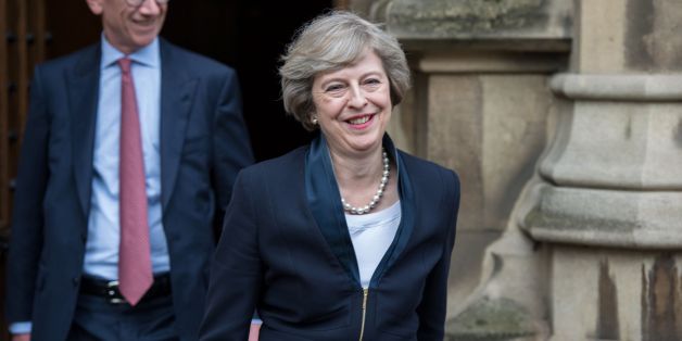 Britain's new Conservative Party leader Theresa May (R) with her husband Philip John May (L), comes out to speak to members of the media at The St Stephen's entrance to the Palace of Westminster in London on July 11, 2016.Theresa May will on Wednesday become the prime minister who leads Britain's into Brexit talks after her only rival in the race to succeed David Cameron pulled out unexpectedly. May was left as the only contender standing after the withdrawal from the leadership race of Andrea L