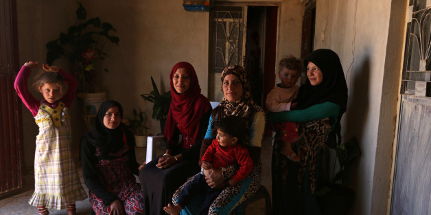Souad Hamidi (3rd L), 19, poses for a photograph with other members of her family inside their home, in the outskirts of Manbij, Aleppo province, Syria June 11, 2016. REUTERS/Rodi Said SEARCH "RODI NIQAB" FOR THIS STORY. SEARCH "THE WIDER IMAGE" FOR ALL STORIES