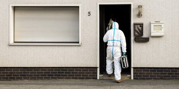 FILE - In this Nov. 13, 2015 file picture a police investigator in protective cloth enters a house in Wallenfels, southern Germany, where police found bodies of multiple babies. A couple have gone on trial Tuesday July 12, 2016 in Germany after the remains of eight babies were found at their apartment in Bavaria last year. The 45-year-old mother, identified only as Andrea G., is charged with four counts of murder in the trial at the Coburg state court and her 55-year-old husband, Johann G., wi