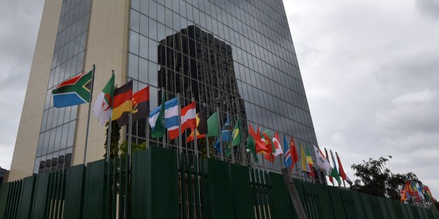 Flags fly on the provisional headquarters of the African Development Bank on September 8, 2014 in Abidjan after a ceremony marking the effective return of the operations of the Bank to Abidjan. The Bank had moved to Tunisia over 10 years ago due to political instability in the Ivory Coast. AFP PHOTO / SIA KAMBOU (Photo credit should read SIA KAMBOU/AFP/Getty Images)