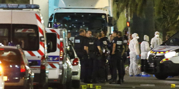 French police forces and forensic officers stand next to a truck July 15, 2016 that ran into a crowd celebrating the Bastille Day national holiday on the Promenade des Anglais killing at least 60 people in Nice, France, July 14. REUTERS/Eric Gaillard