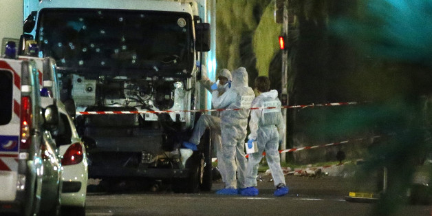 French police forensic officers stand next to a truck July 15, 2016 that ran into a crowd celebrating the Bastille Day national holiday on the Promenade des Anglais killing at least 60 people in Nice, France, July 14. REUTERS/Eric Gaillard