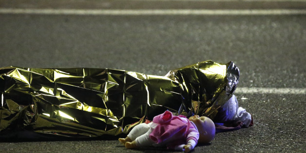 ATTENTION EDITORS - VISUAL COVERAGE OF SCENES OF INJURY OR DEATH - A body is seen on the ground July 15, 2016 after at least 30 people were killed in Nice, France, when a truck ran into a crowd celebrating the Bastille Day national holiday July 14. REUTERS/Eric Gaillard