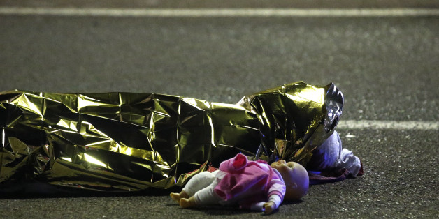 ATTENTION EDITORS - VISUAL COVERAGE OF SCENES OF INJURY OR DEATH - A body is seen on the ground July 15, 2016 after at least 30 people were killed in Nice, France, when a truck ran into a crowd celebrating the Bastille Day national holiday July 14. REUTERS/Eric Gaillard