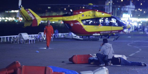 ATTENTION EDITORS - VISUAL COVERAGE OF SCENES OF INJURY OR DEATH - An injured individual is seen on the ground after at least 30 people were killed in Nice, France, when a truck ran into a crowd celebrating the Bastille Day national holiday July 14, 2016. REUTERS/Eric Gaillard