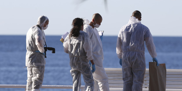 Forensic police work on the scene of a truck attack in Nice, southern France, Friday, July 15, 2016. A large truck mowed through revelers gathered for Bastille Day fireworks in Nice, killing more than 80 people and sending people fleeing into the sea as it bore down for more than a mile along the Riviera city's famed waterfront promenade. (AP Photo/Luca Bruno)